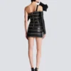 Asymmetrisk bodycon-klänning i läder med kedjor Asymmetrisk bodycon-klänning i läder med kedjor