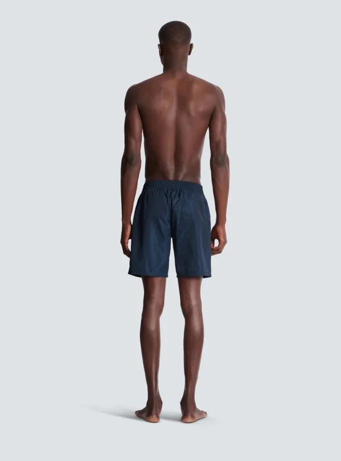 Badshorts med Balmain College-logotyp