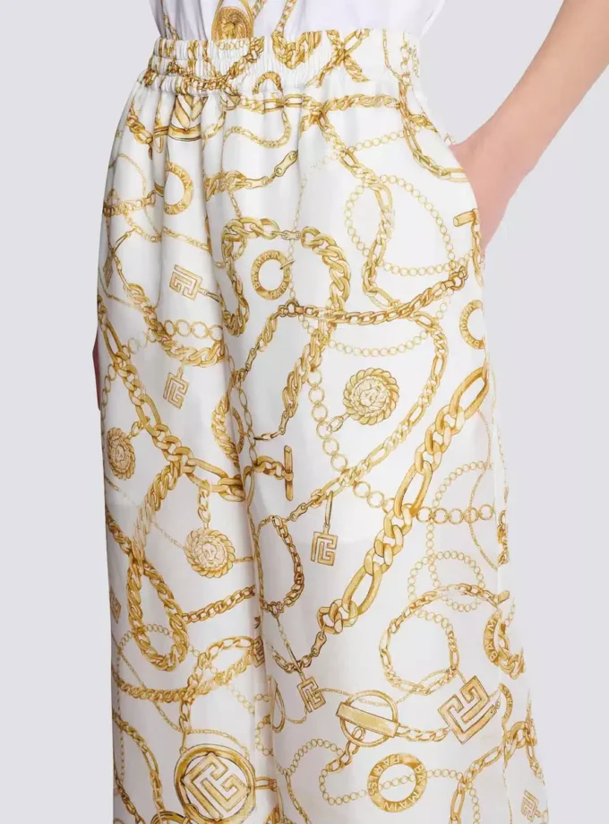 Flödande byxor i tryckt siden med Balmain Chains-mönster Flödande byxor i tryckt siden med Balmain Chains-mönster