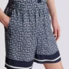 Flödande shorts med monogram